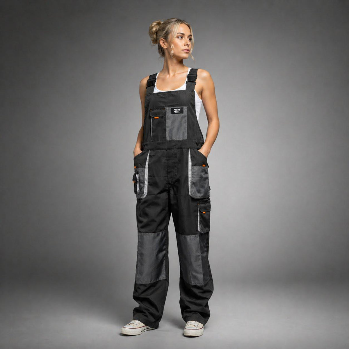 Black bib overalls with reinforced knees and example logo.
