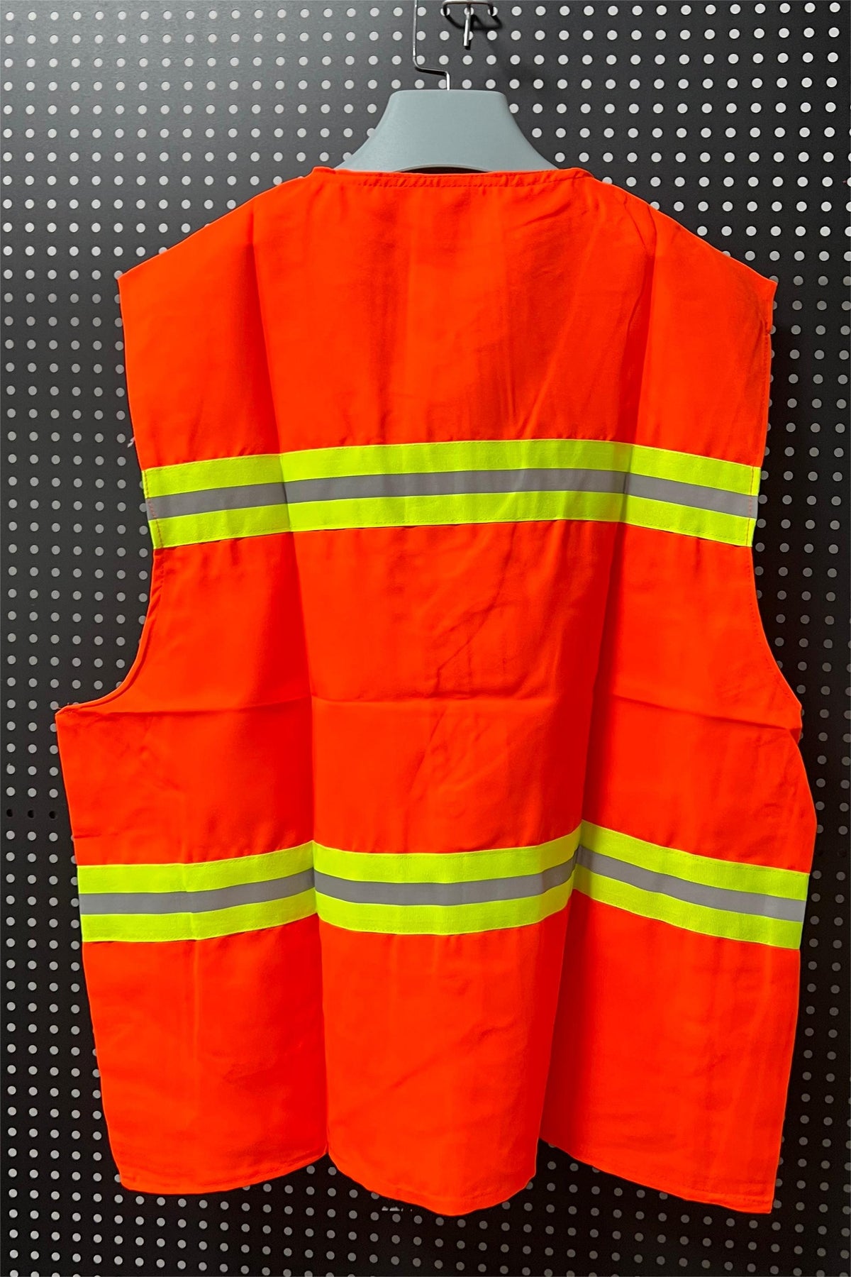 Orange reflective vest displayed on a hanger.