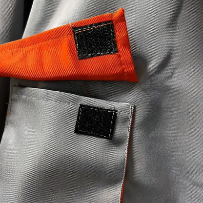 Light gray coverall pocket detail with orange flap