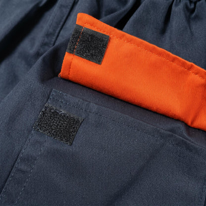 Navy blue coverall pocket detail with orange flap